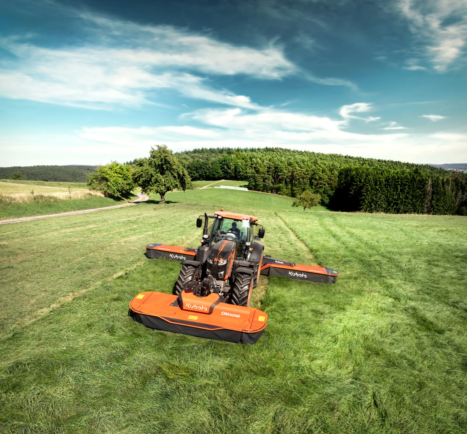 Kubota DM4032 Front Plain Mower, mowing in a green field